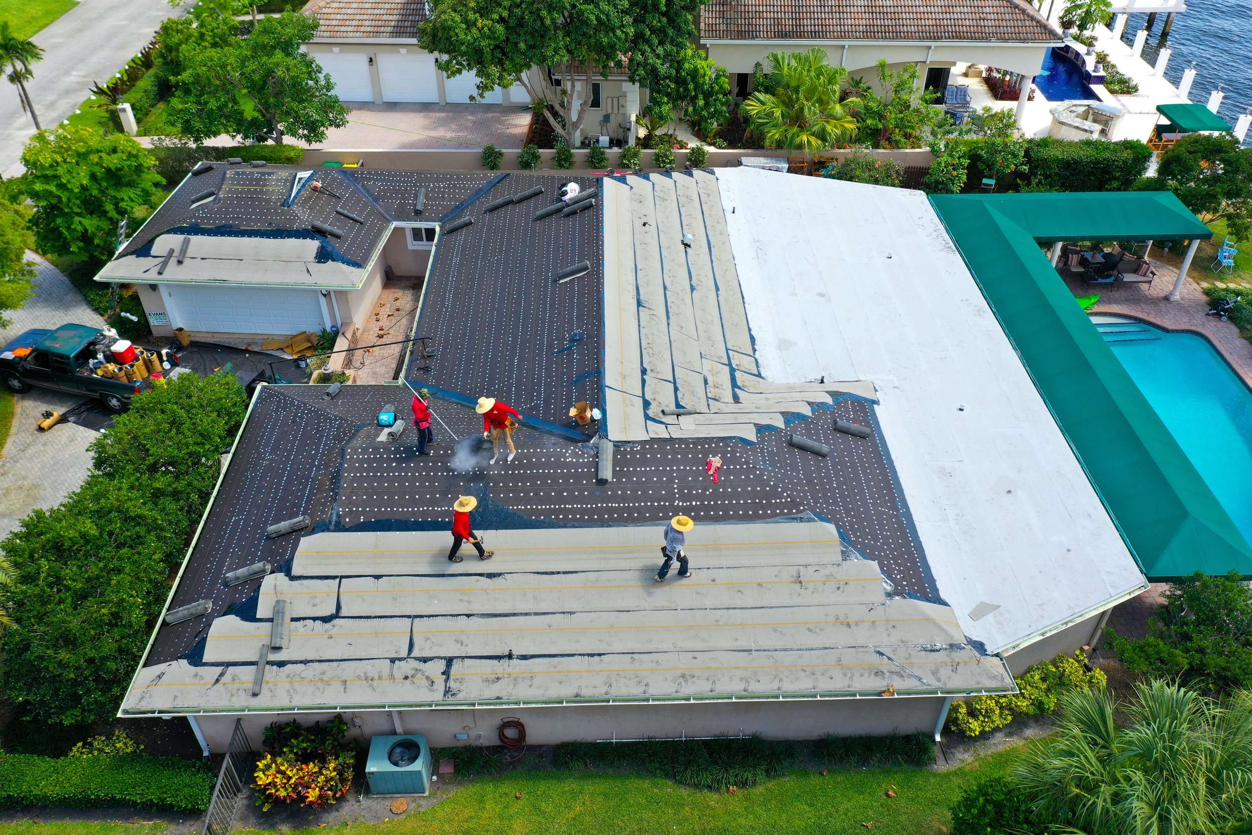 Aerial view of a tile re-roof in progress, with the old roof stripped down to the underlayment